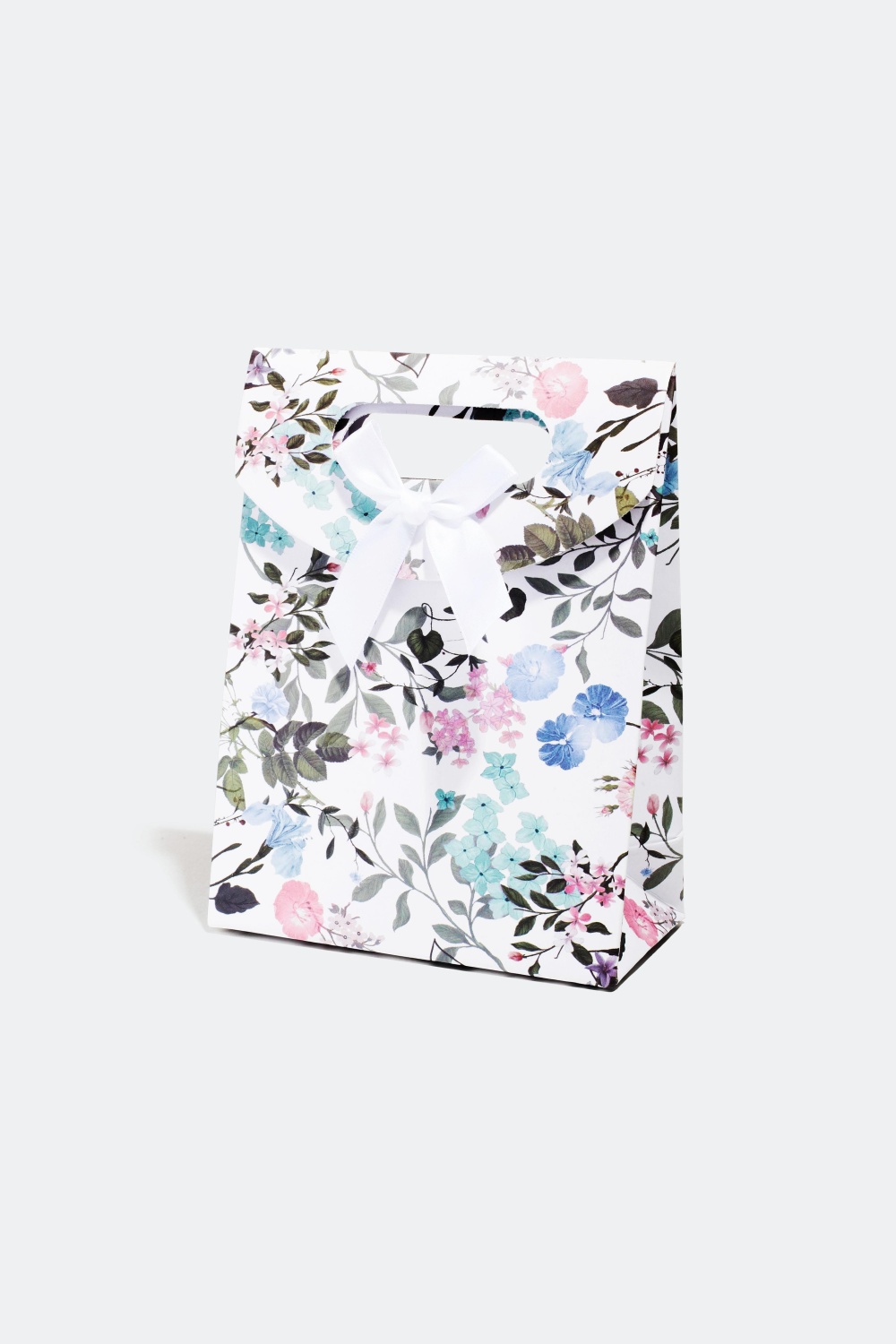 Lahjapakkaus kukkakuviolla ja rusetilla