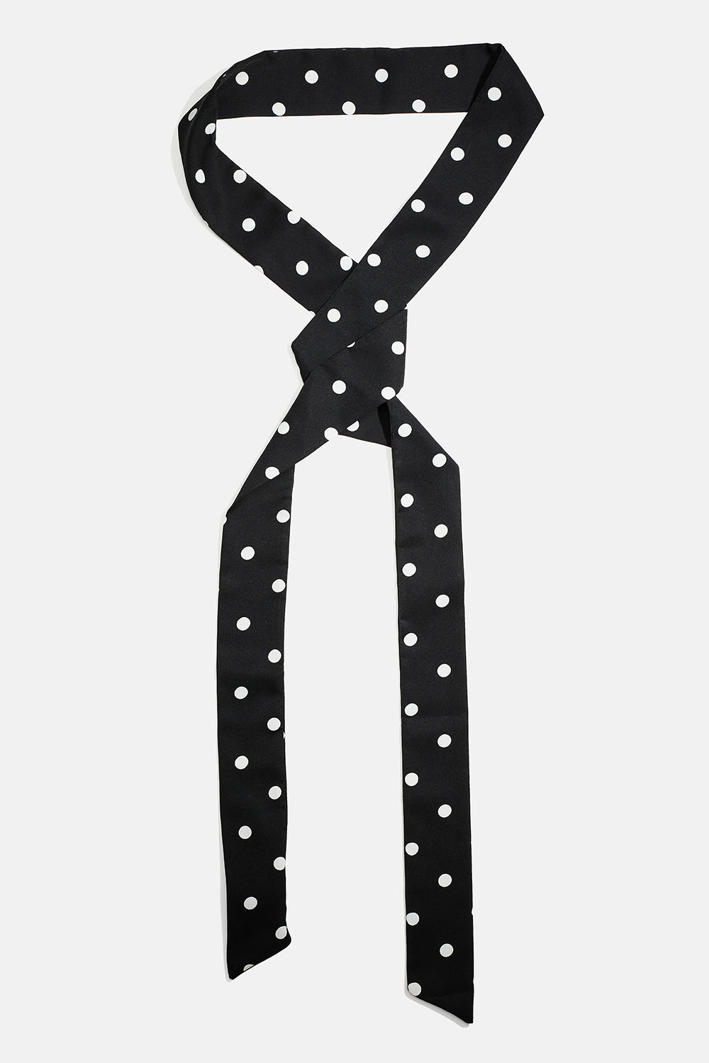 Kapea musta huivi, jossa valkoisia pilkkuja