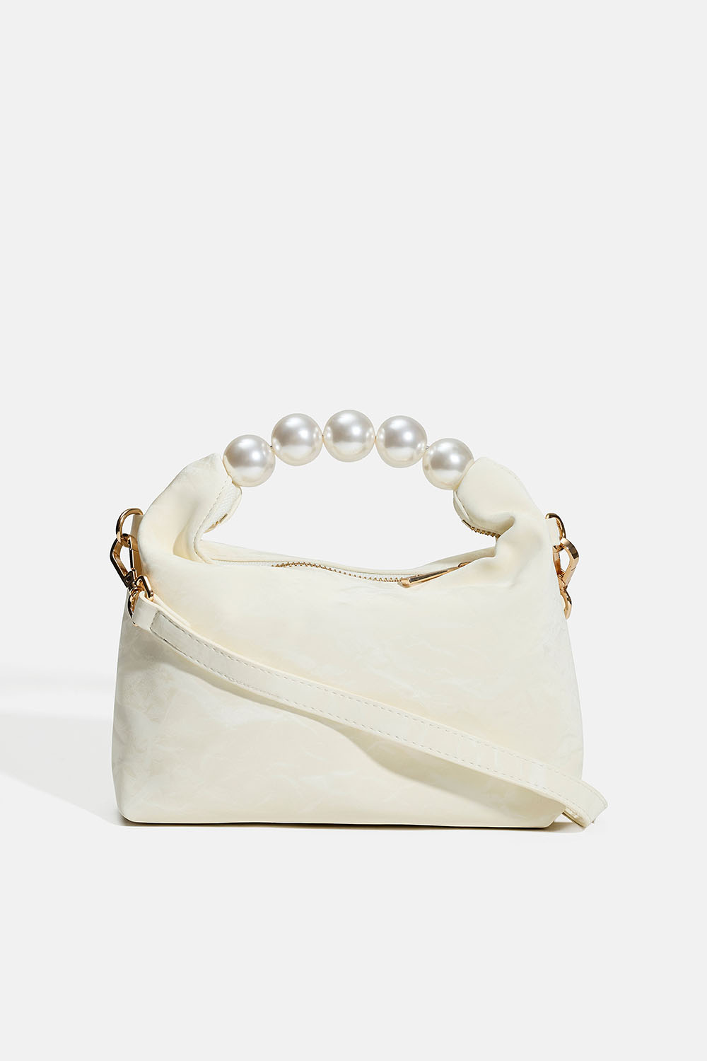 Pieni valkoinen laukku helmiäiskahvalla