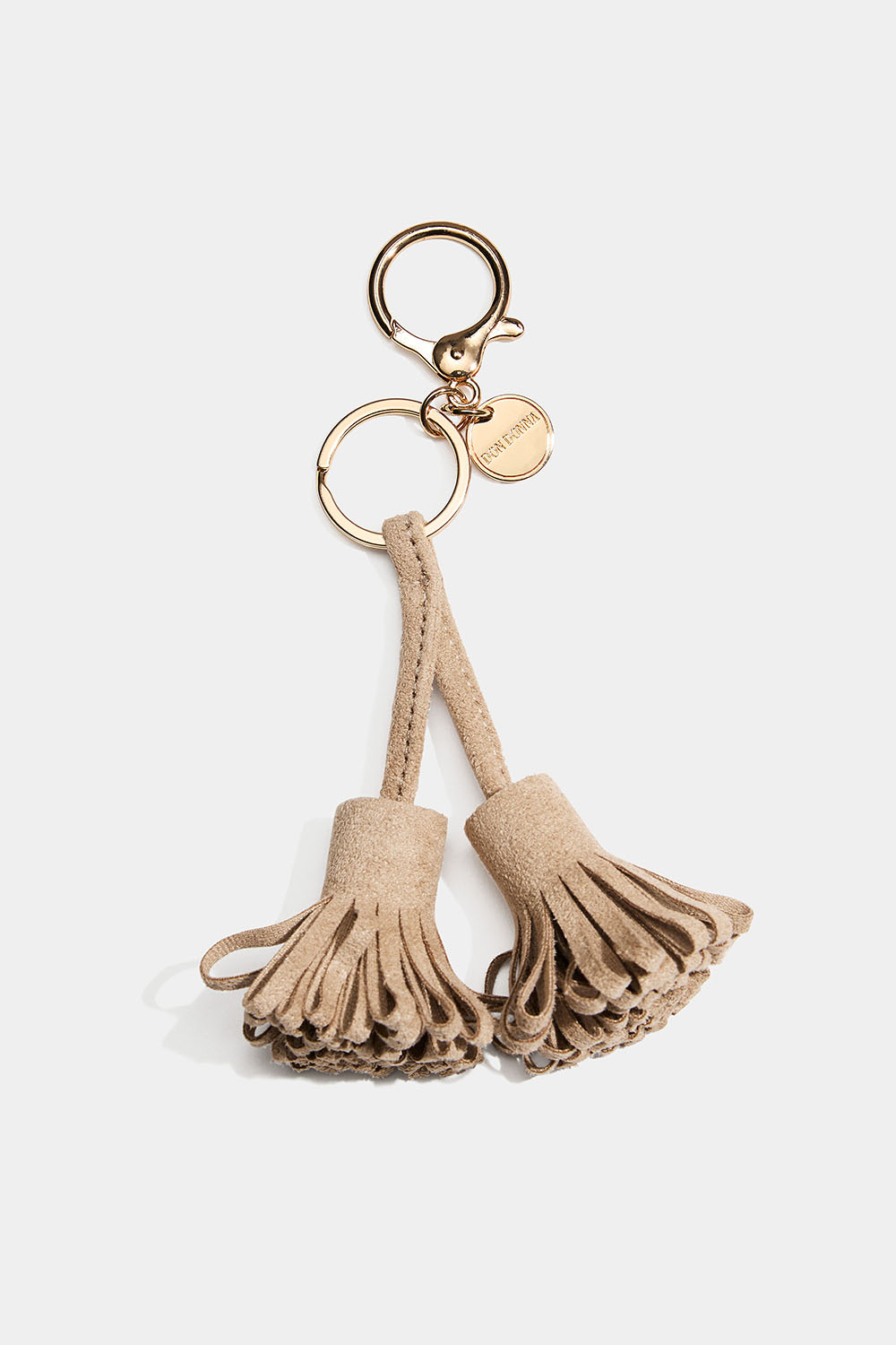 Laukkukoriste beigeillä tupsuilla