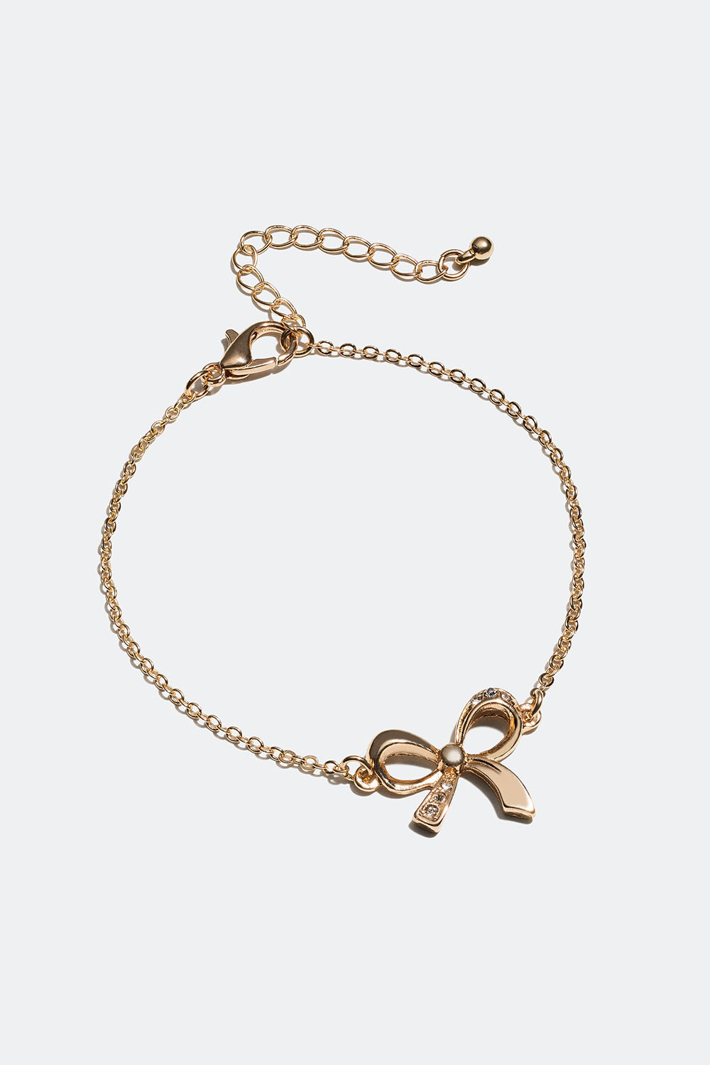 Kullanvärinen rannerengas, jossa rusetti ja lasikiviä