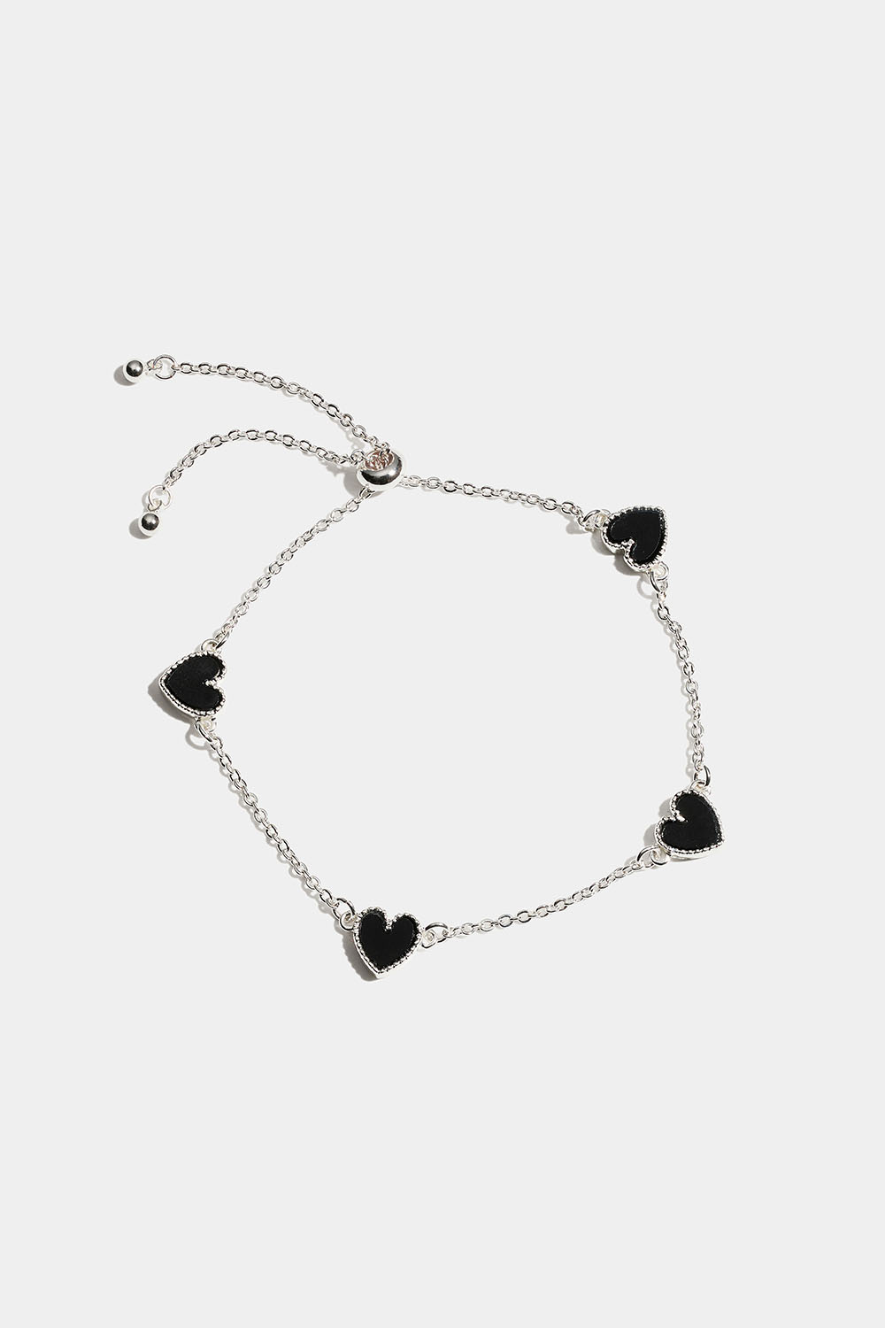 Rannekoru, jossa mustia sydämiä