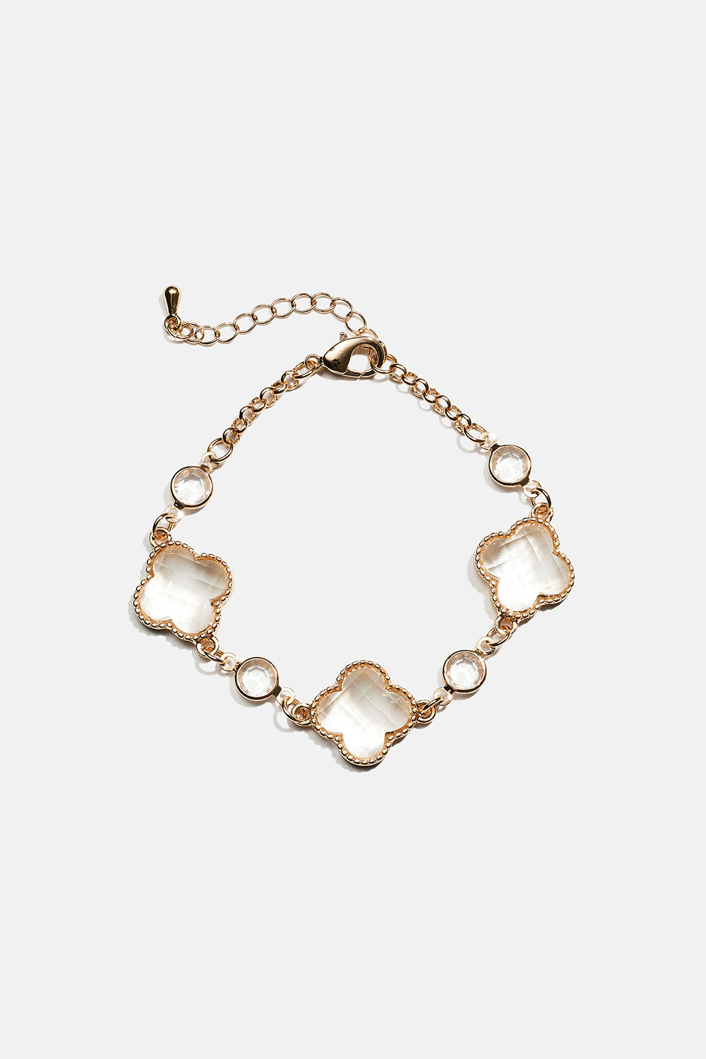 Rannekoru valkoisesta lasista valmistetuilla kukkasilla