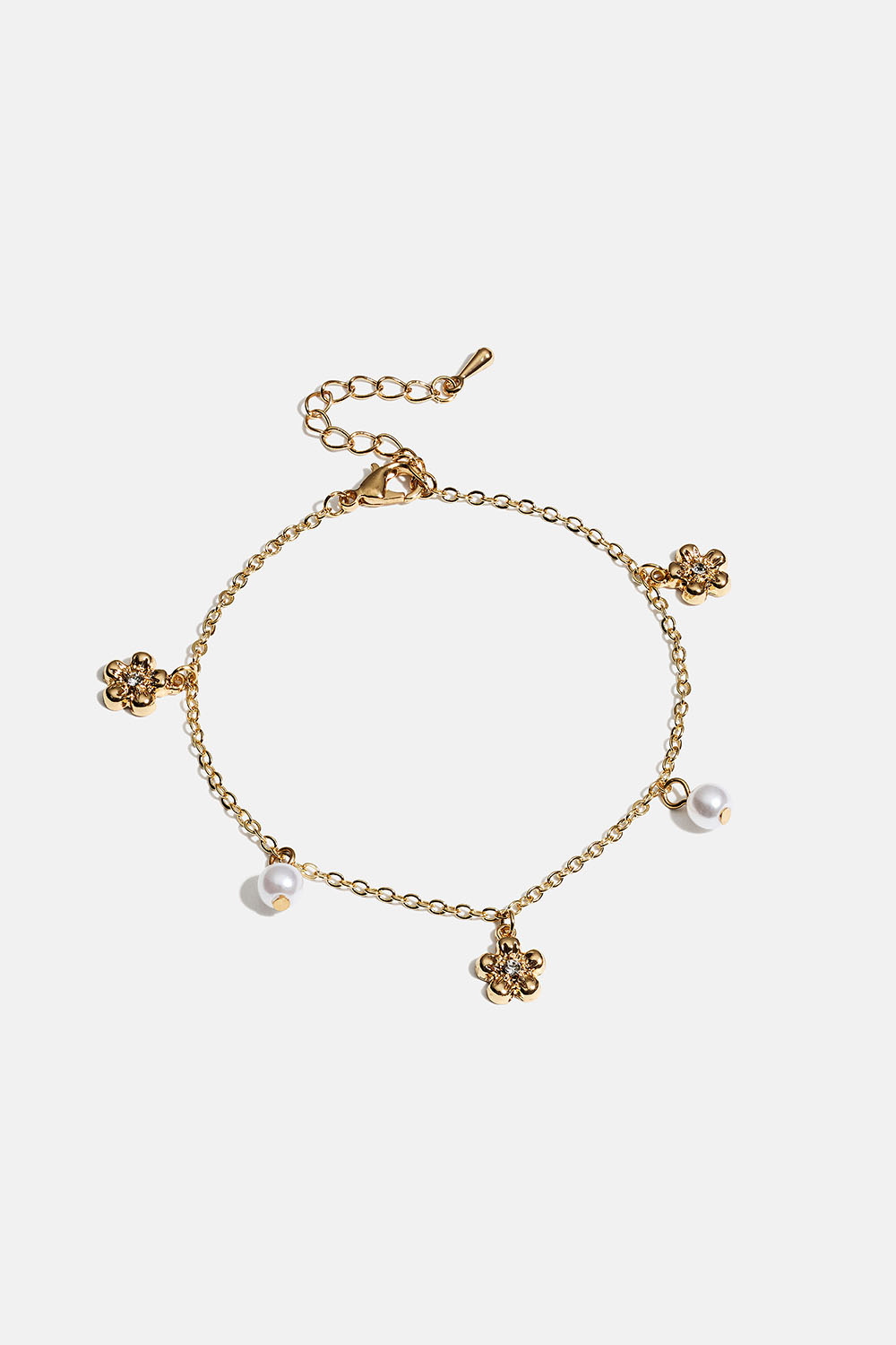 Kullanvärinen rannekoru, jossa kukkia ja valkoisia helmiä