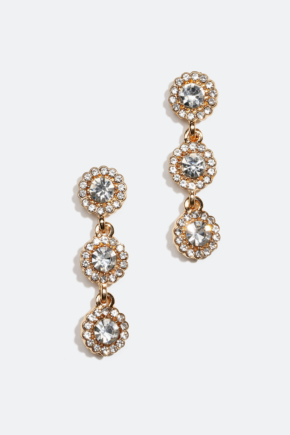 Kullanväriset strassikorvakorut, joissa kolme pyöreää lasikiveä