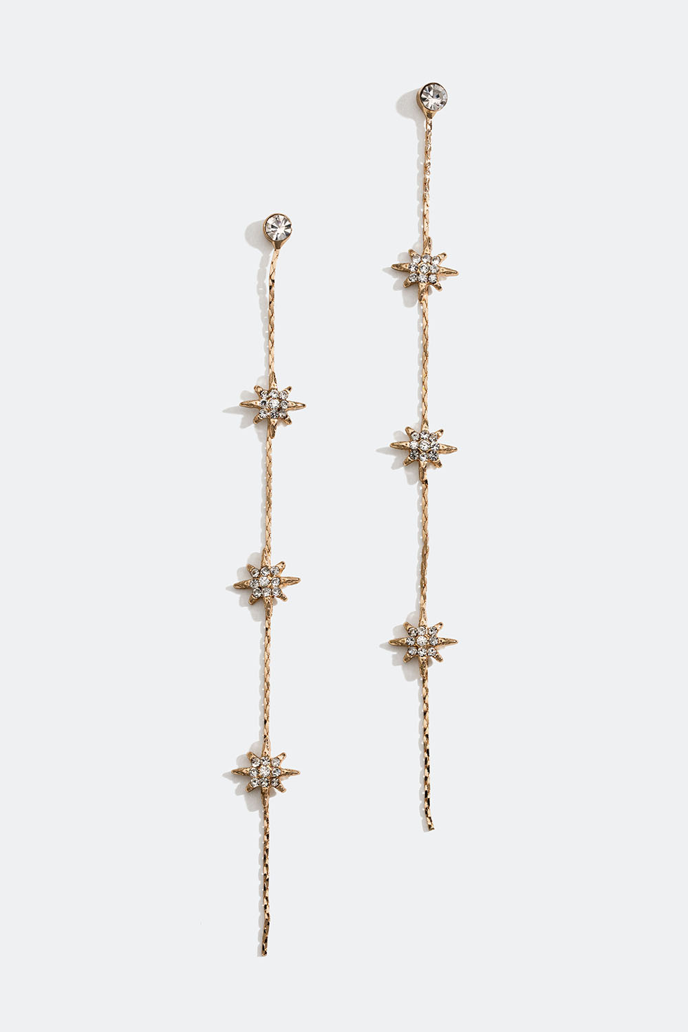 Pitkät kullanväriset ketjukorvakorut, joissa tähtiä ja lasikiviä