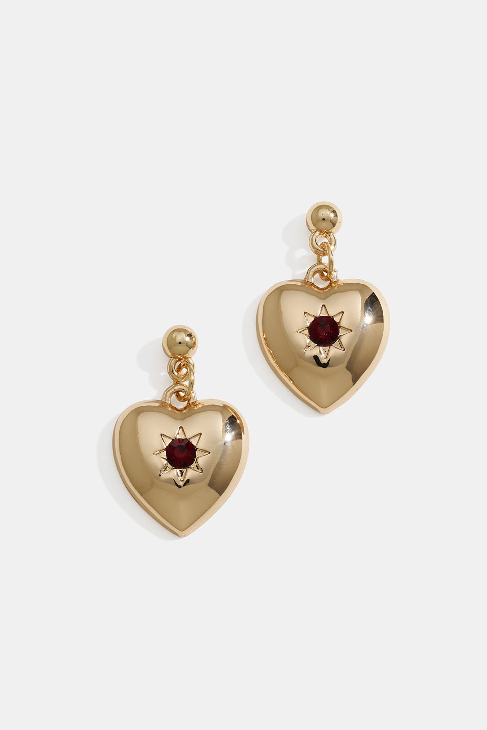 Kullanväriset sydänkorvakorut, joissa on tähtiä