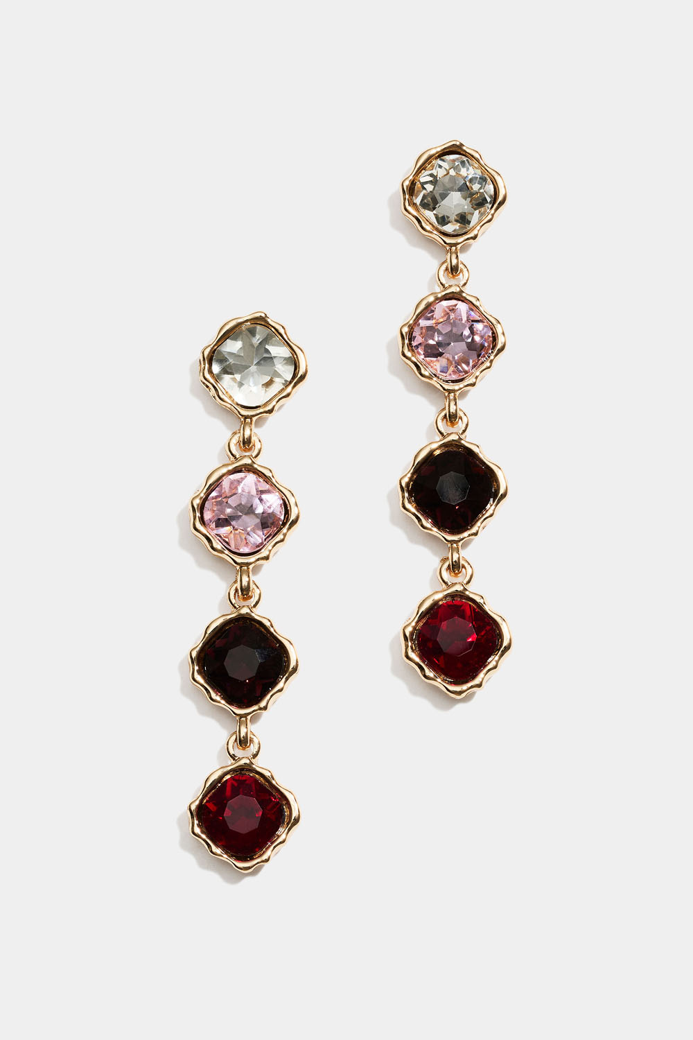 Korvakorut, joissa vaaleanpunaisia ja punaisia roikkuvia lasikiviä 