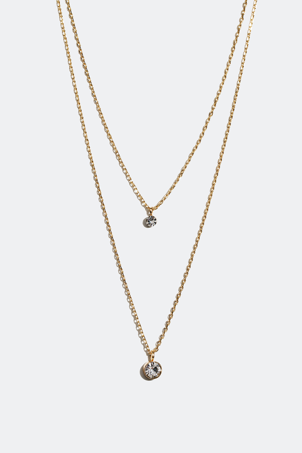 Kullanvärinen, kaksinkertainen kaulakoru, jossa on kaksi pientä lasikiveä