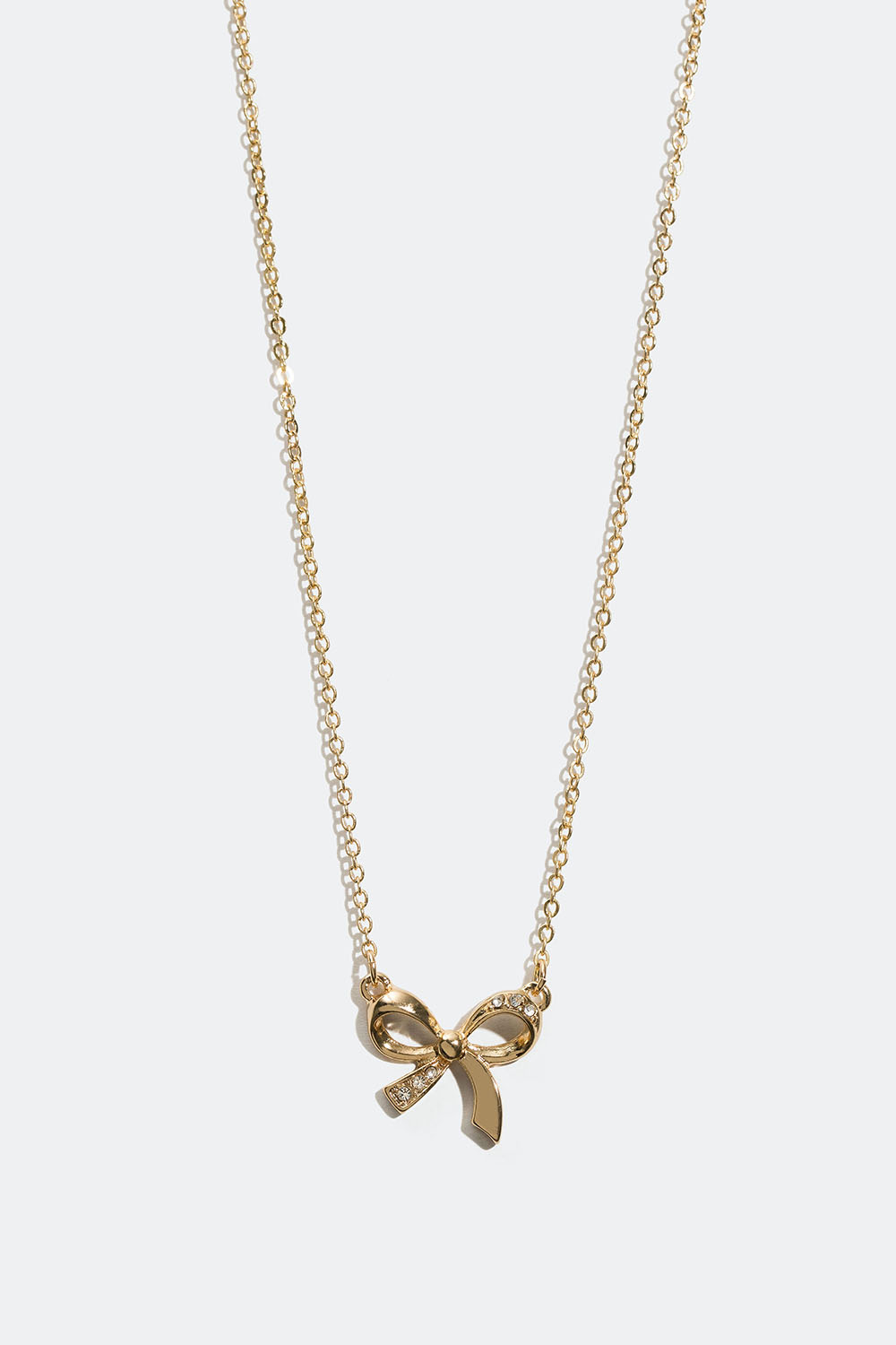 Kullanvärinen kaulakoru, jossa rusetti ja lasikiviä