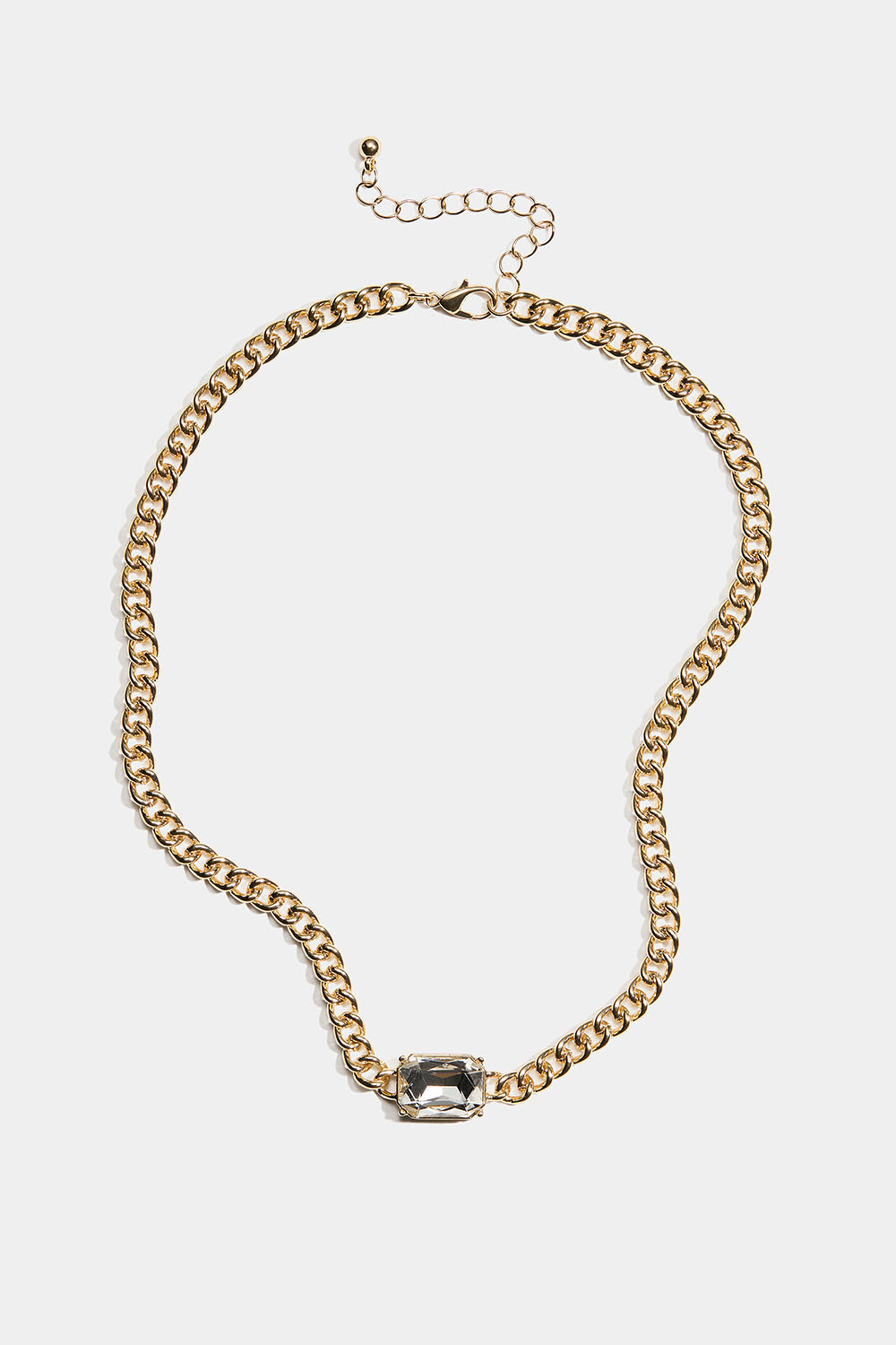 Kullanvärinen kaulakoru, jossa on rouhea ketju ja iso lasikivi