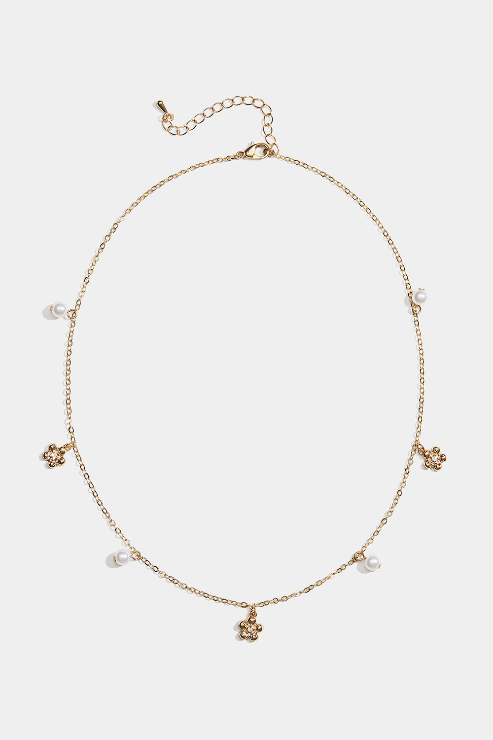 Kullanvärinen kaulakoru, jossa kukkia ja valkoisia helmiä