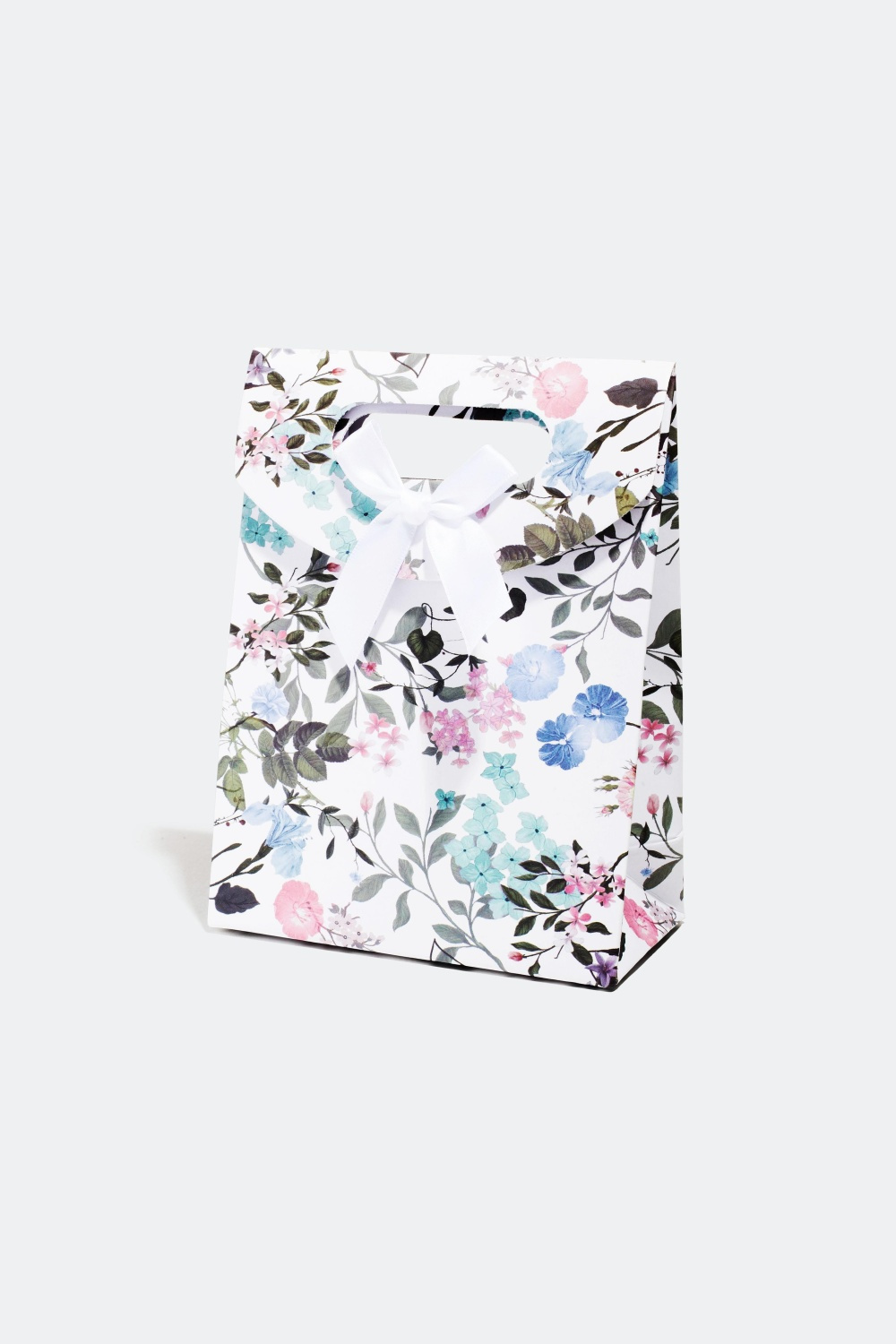 Lahjapakkaus kukkakuviolla ja rusetilla