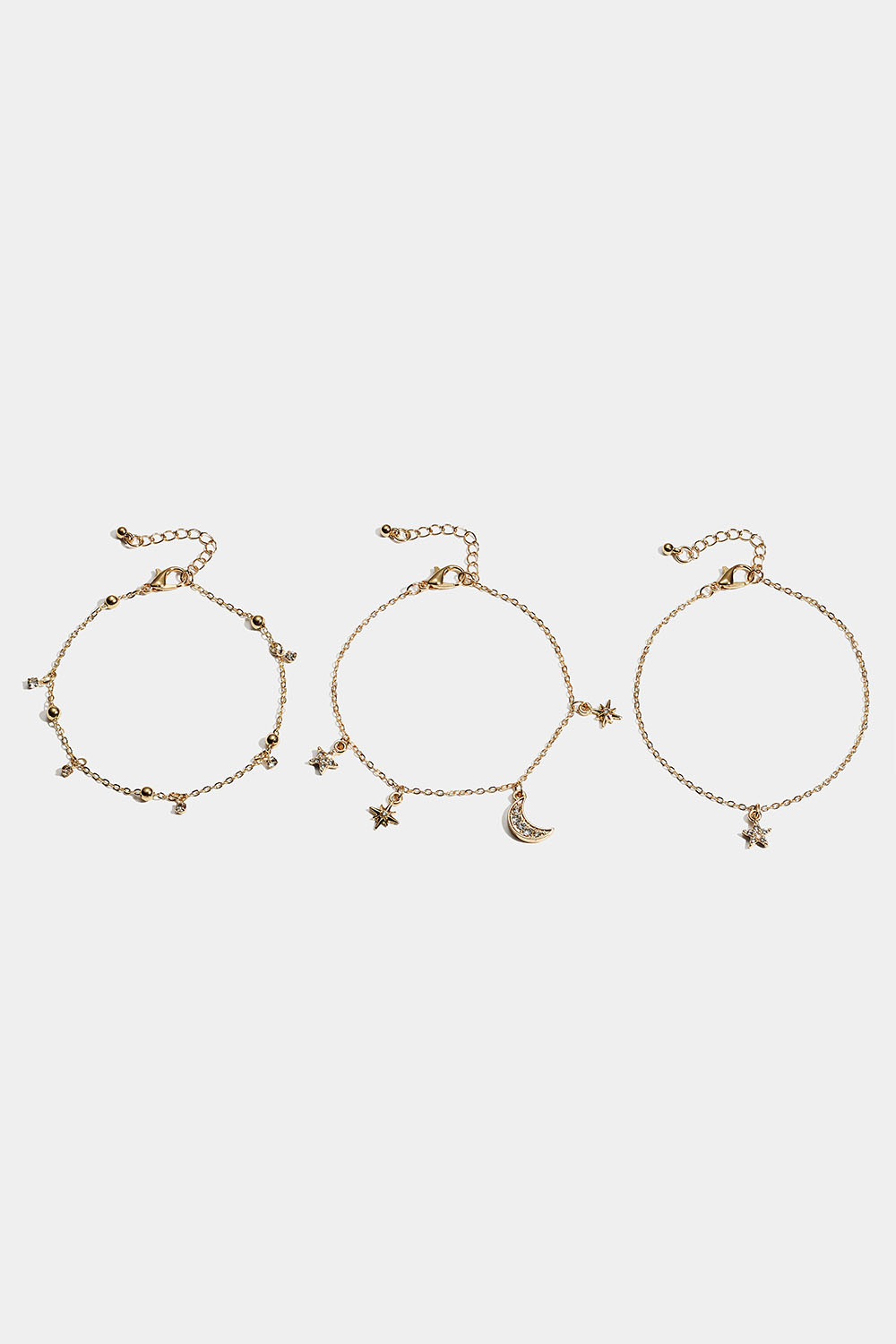 Rannekoru, jossa on tähti- ja kuuriipuksia 