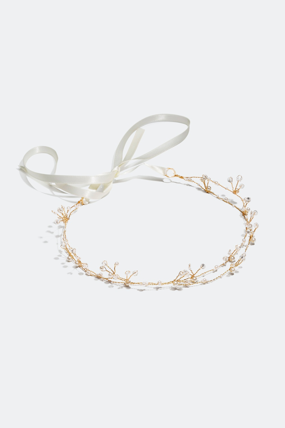 Kullanvärinen hiuskoriste, jossa on kiviä ja helmiä