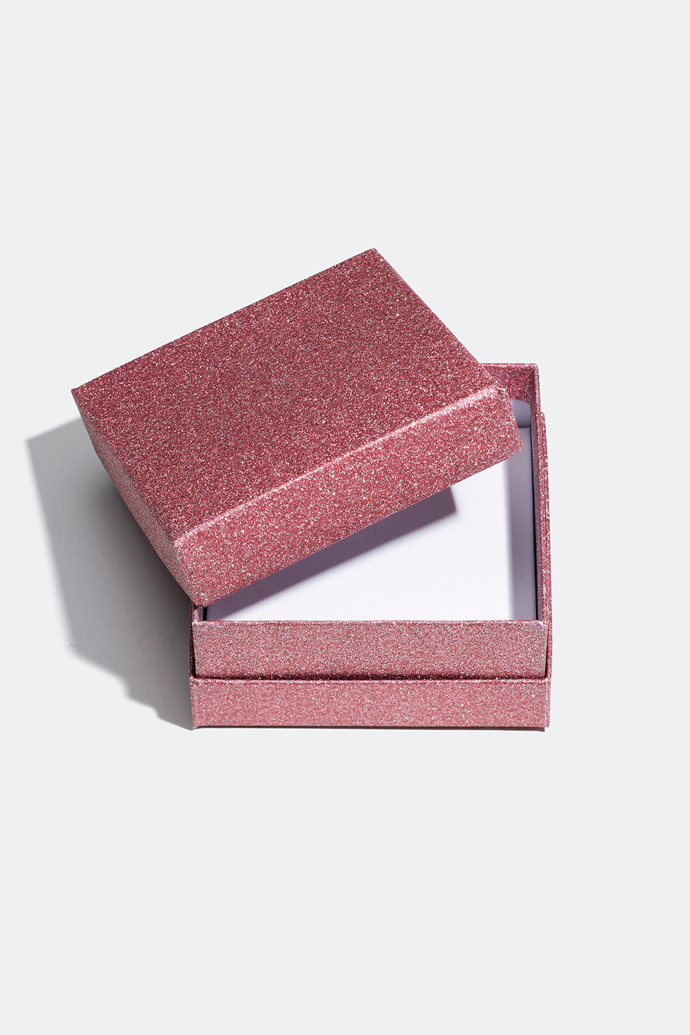 Vaaleanpunainen lahjapakkaus glitterikoristeilla