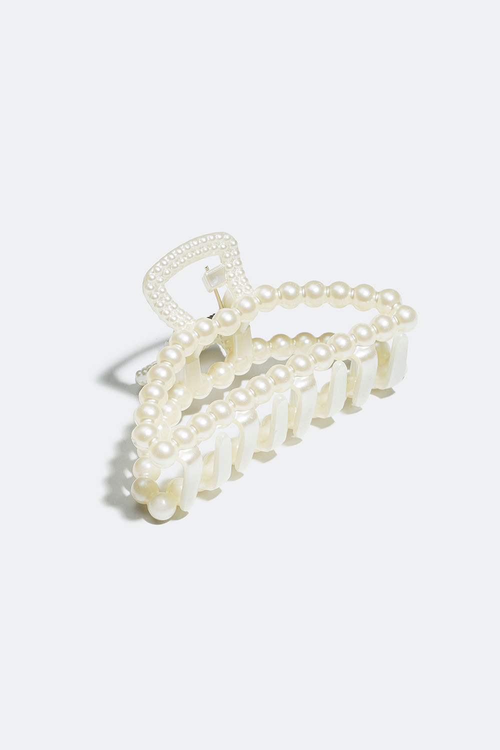 Hiussolki, jossa valkoisia muovihelmiä