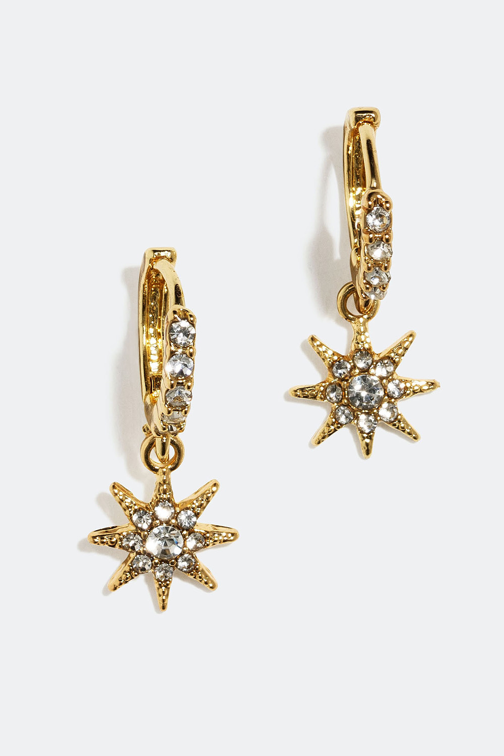 Korvarenkaat, joissa tähden muotoiset riipukset ja lasikiviä