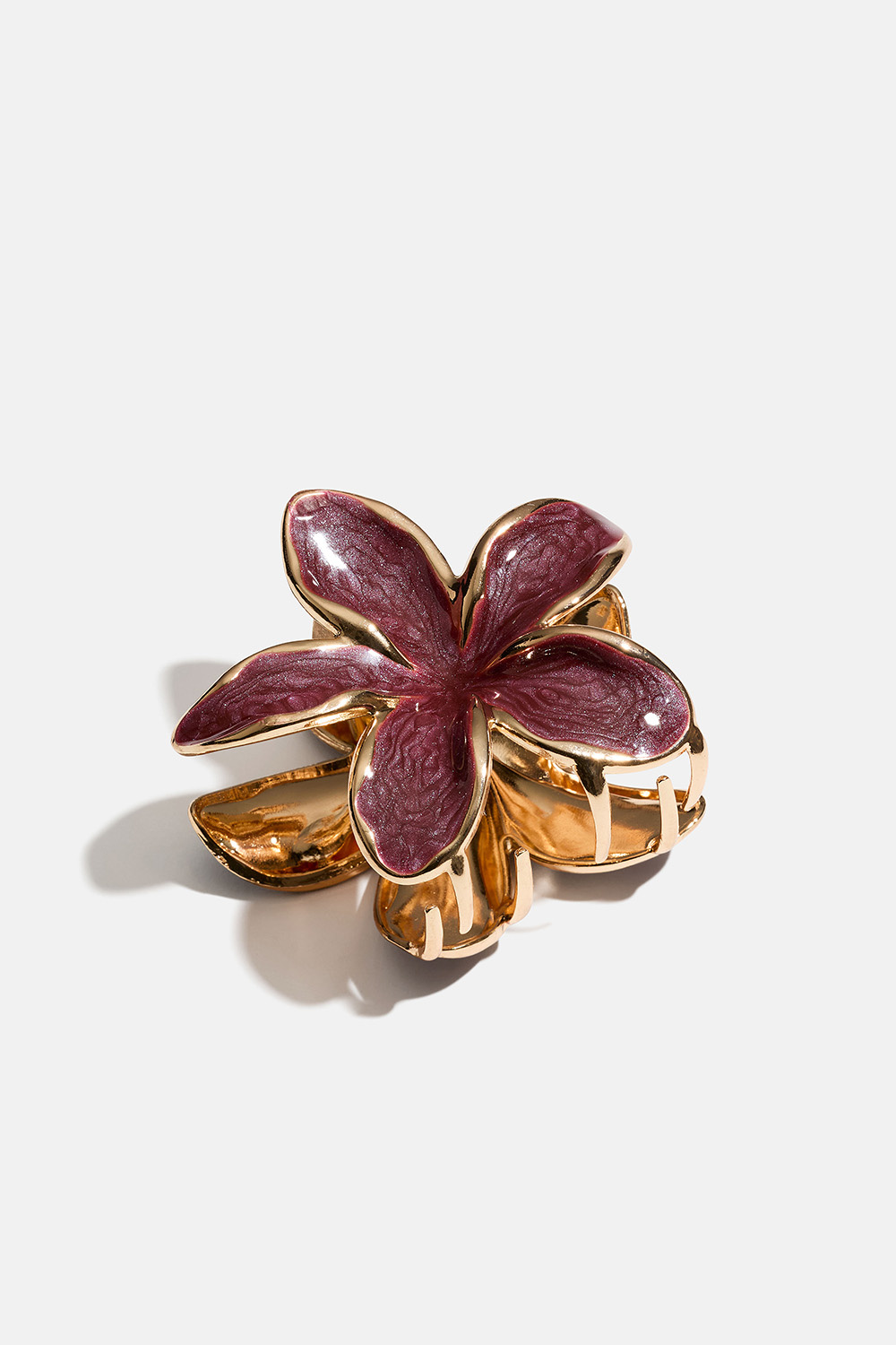 Viininpunainen, kukan muotoinen hiusklipsi kullanvärisestä metallista