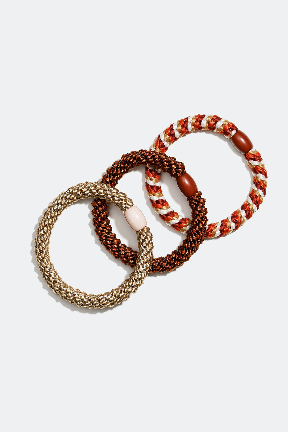 Sekoitus ruskeita ja beigejä punottuja hiuslenkkejä, 3 kpl