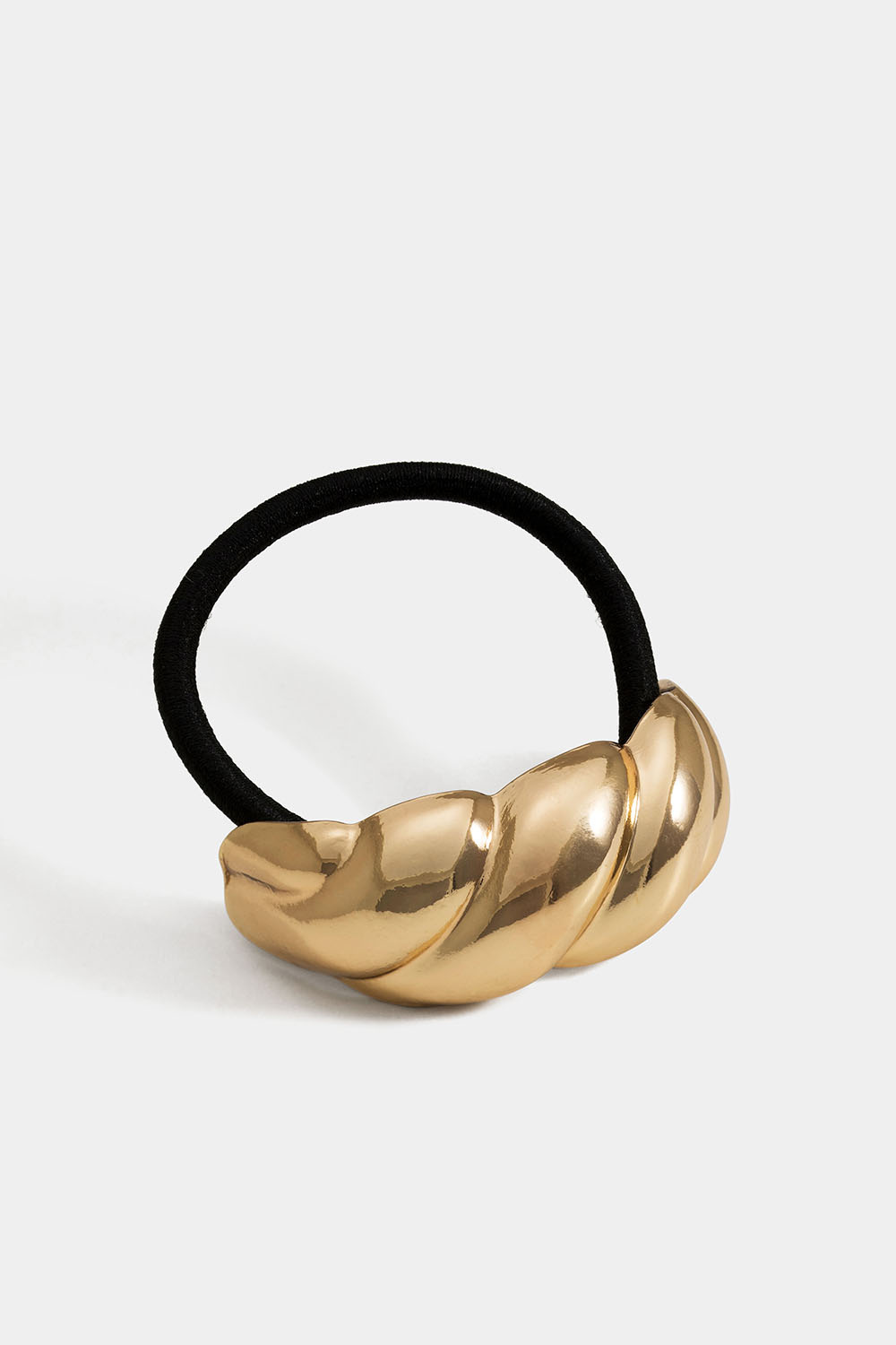 Hiuslenkki, jossa on kultakoriste kullanvärisestä, kierteisestä metallista