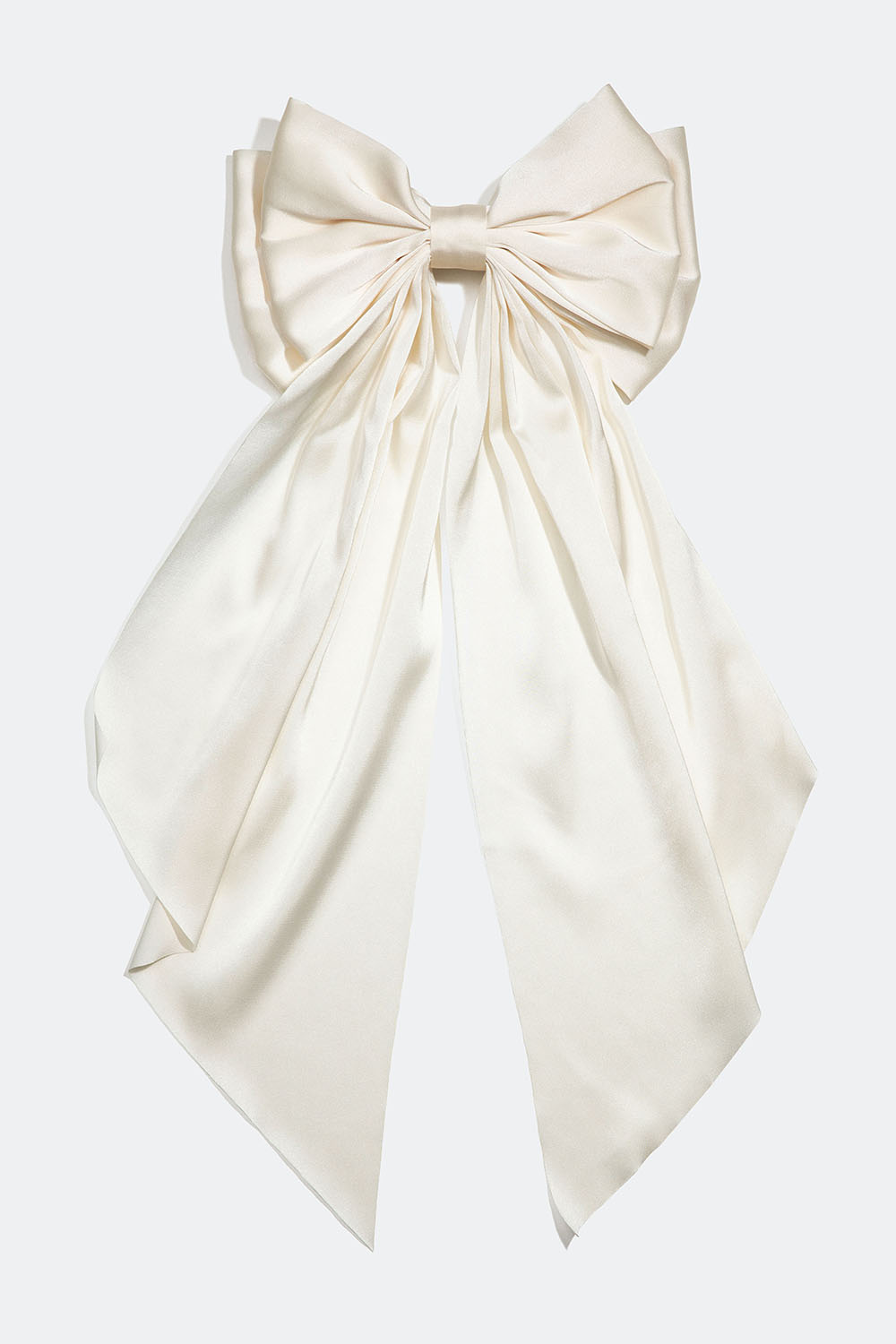 Hiussolki, jossa on suuri, valkoisesta keinosilkistä valmistettu rusetti.