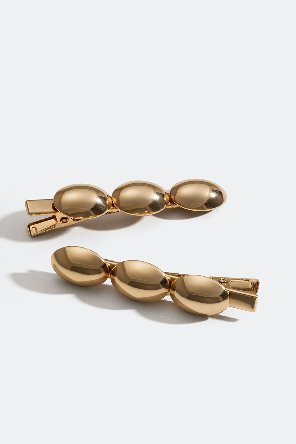 Kullanväriset hiussoljet, joissa soikeita laattoja, 2 kpl