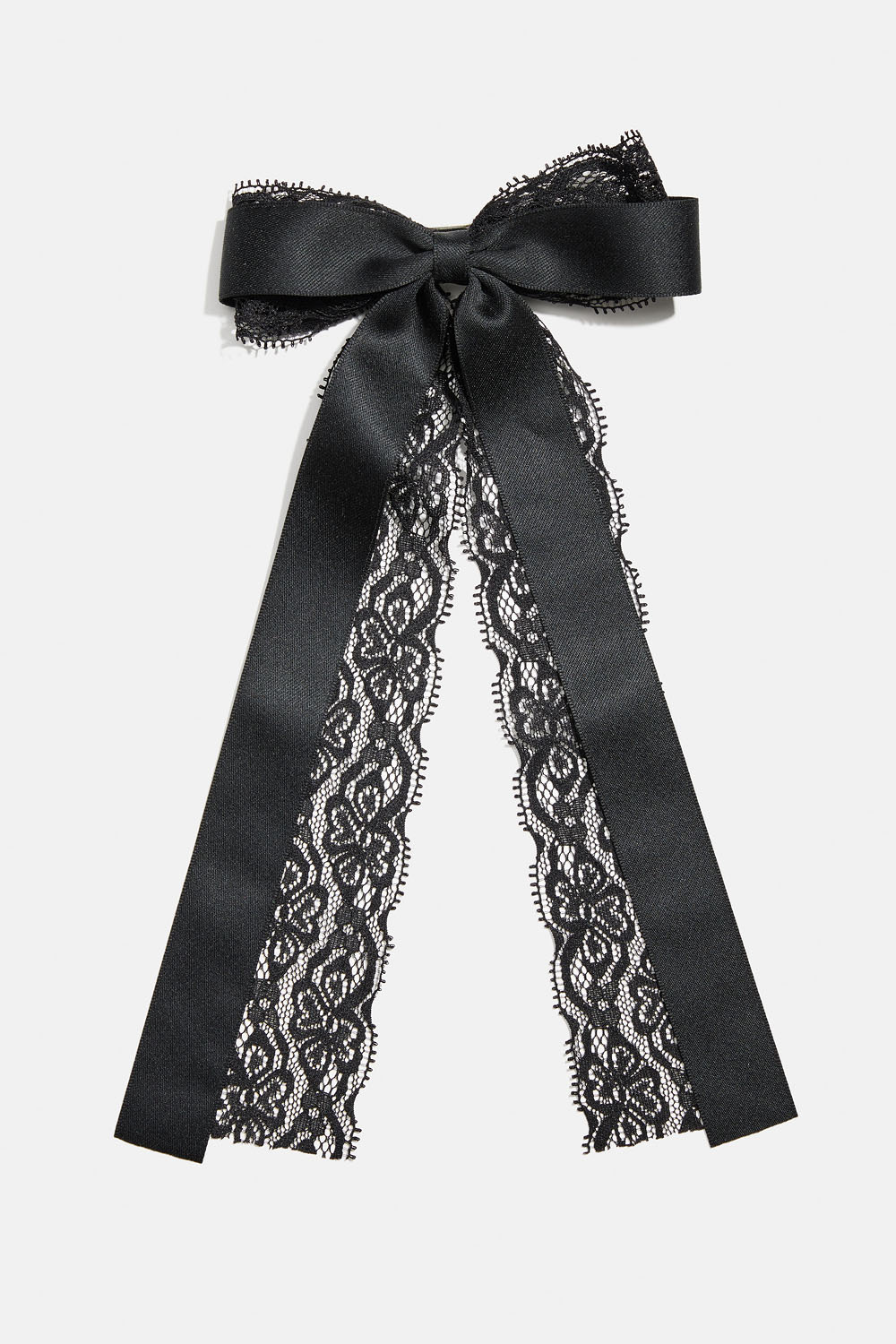 Hiussolki, jonka kärjessä on rusetti pitsistä ja nauhasta