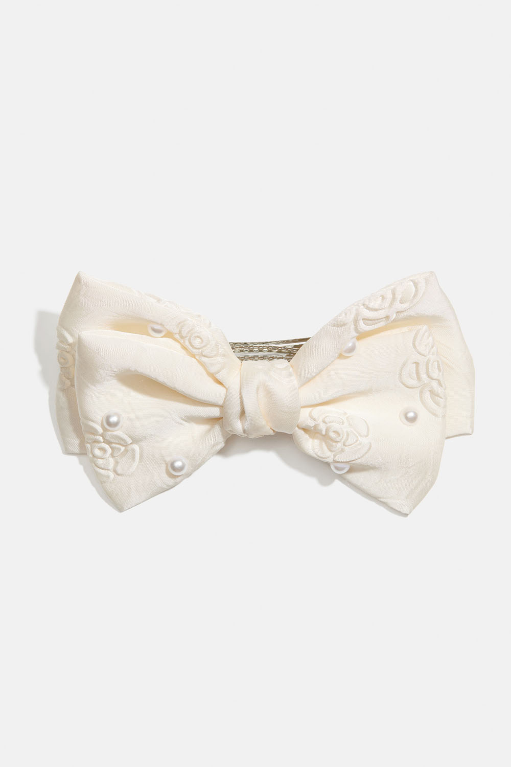 Hiussolki, jossa valkoinen rusetti, helmiä ja ruusukuvio