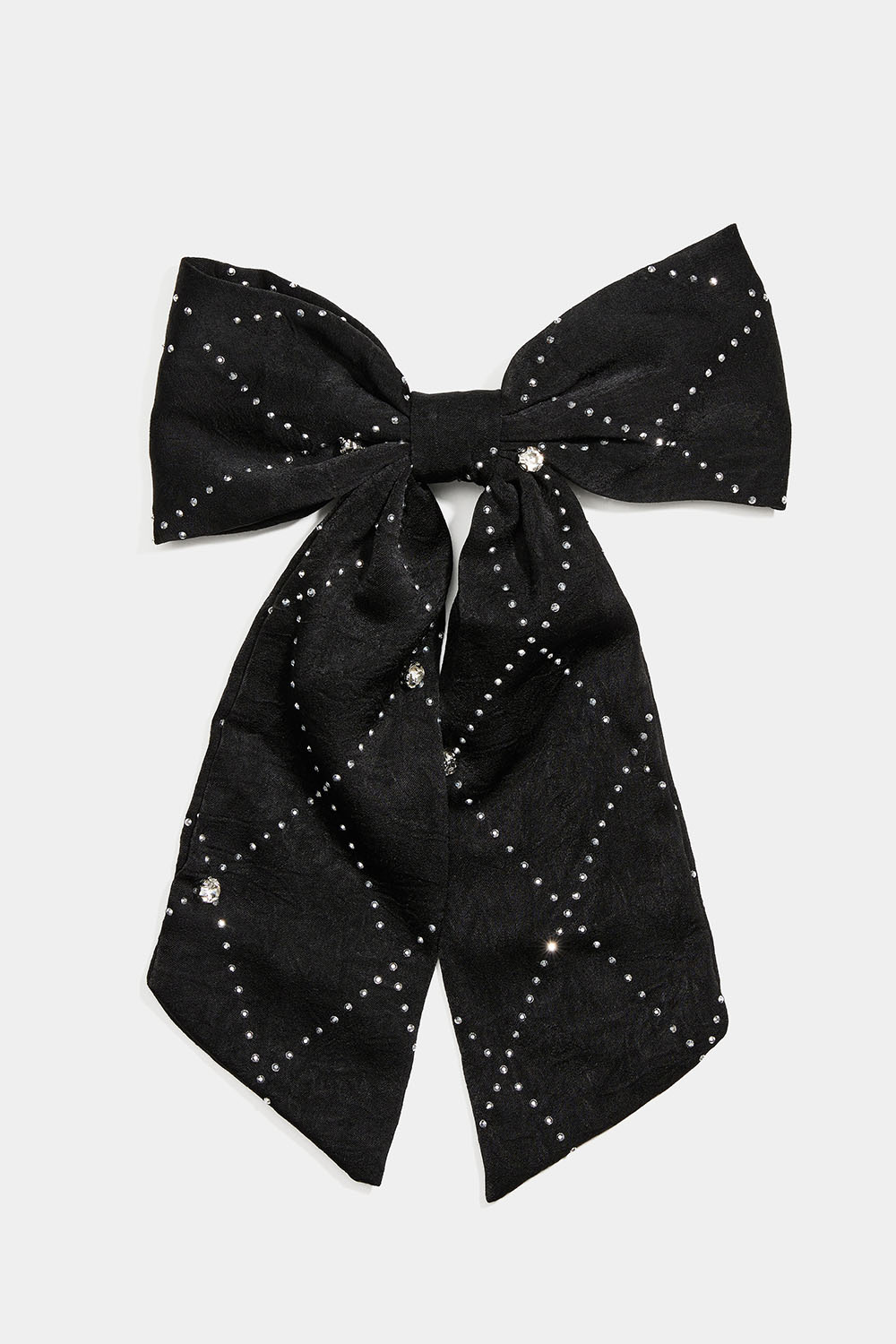 Hiussolki, jossa musta rusetti, pieniä niittejä sekä kiviä