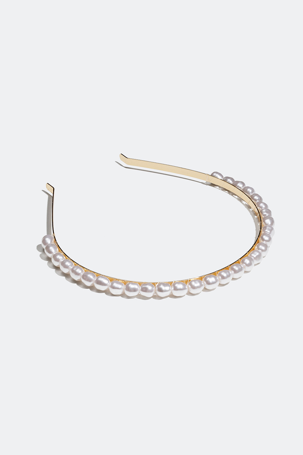 Kapea hiuspanta helmillä