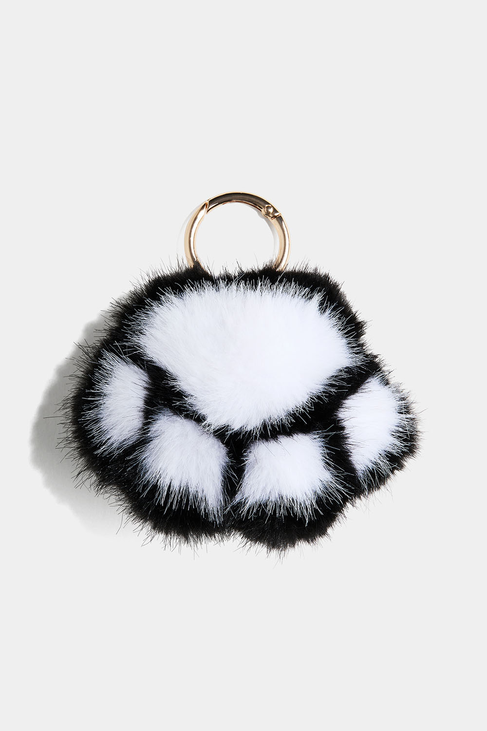 Mustavalkoinen pörröinen tassu avaimenperä
