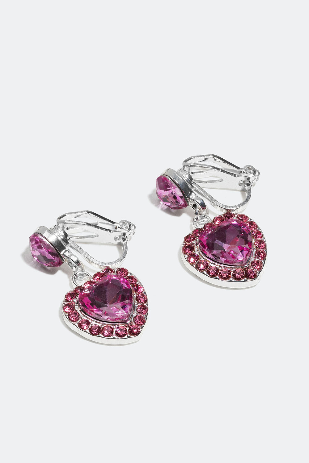 Klipsikorvakorut sydämillä ja vaaleanpunaisilla lasikivillä