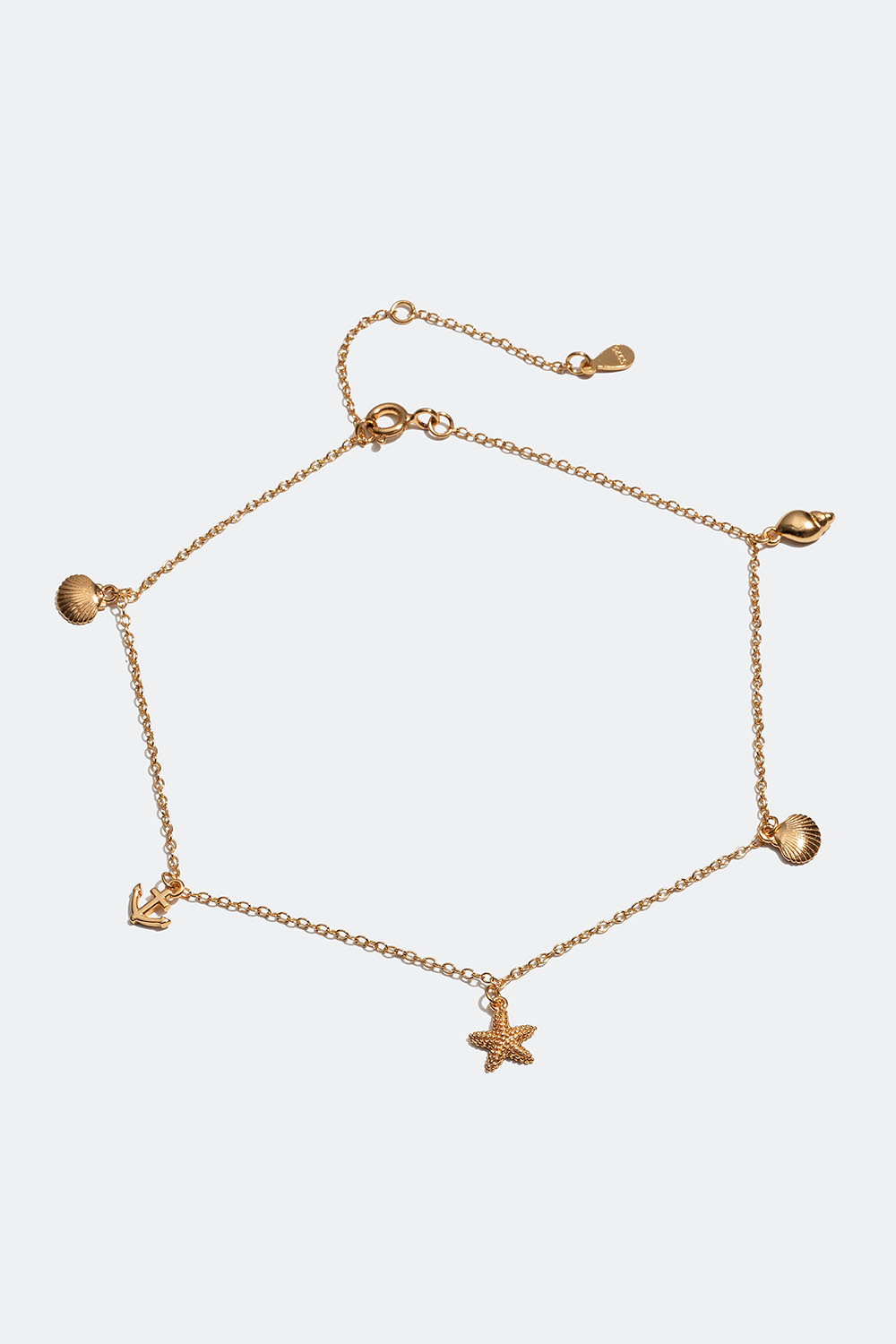 Rannekoru 18k kullattua hopeaa, jossa on simpukoita, meritähti ja ankkuri