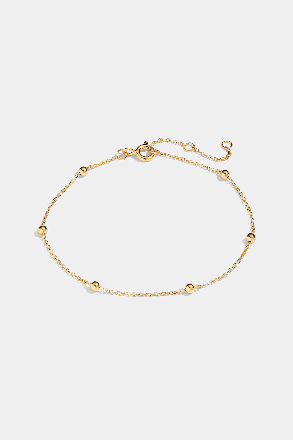 Ohut 18k kullattu hopearannekoru, jossa pieniä palloja.