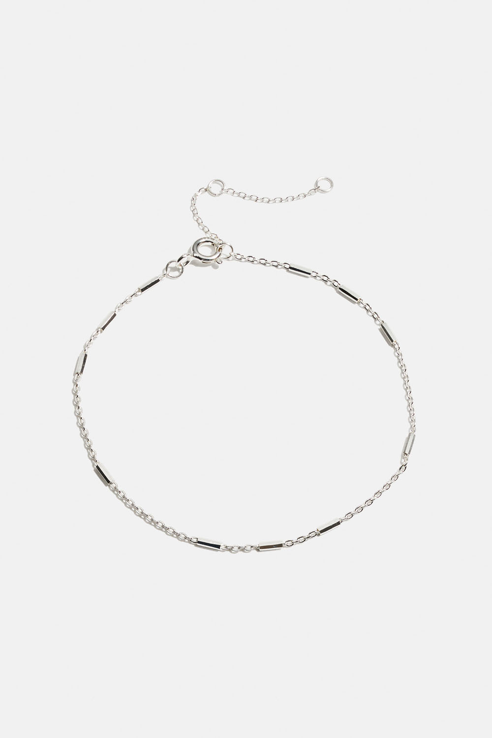 Aito hopearannekoru, jossa pieniä sauvoja