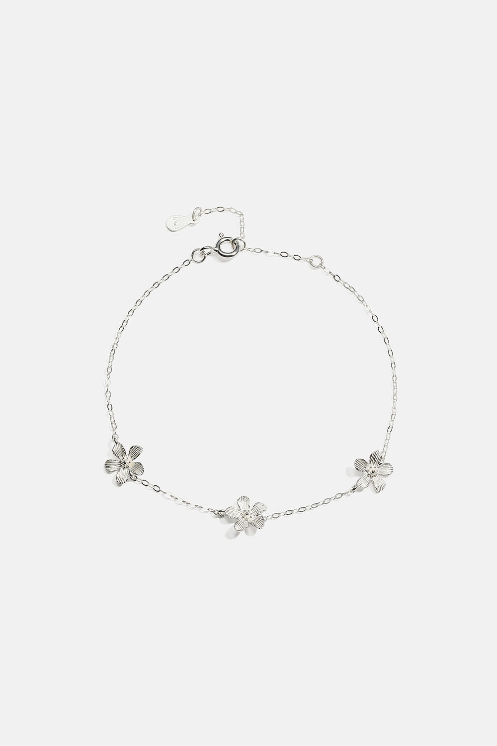 Aito hopearannekoru, jossa teksturoituja kukkia