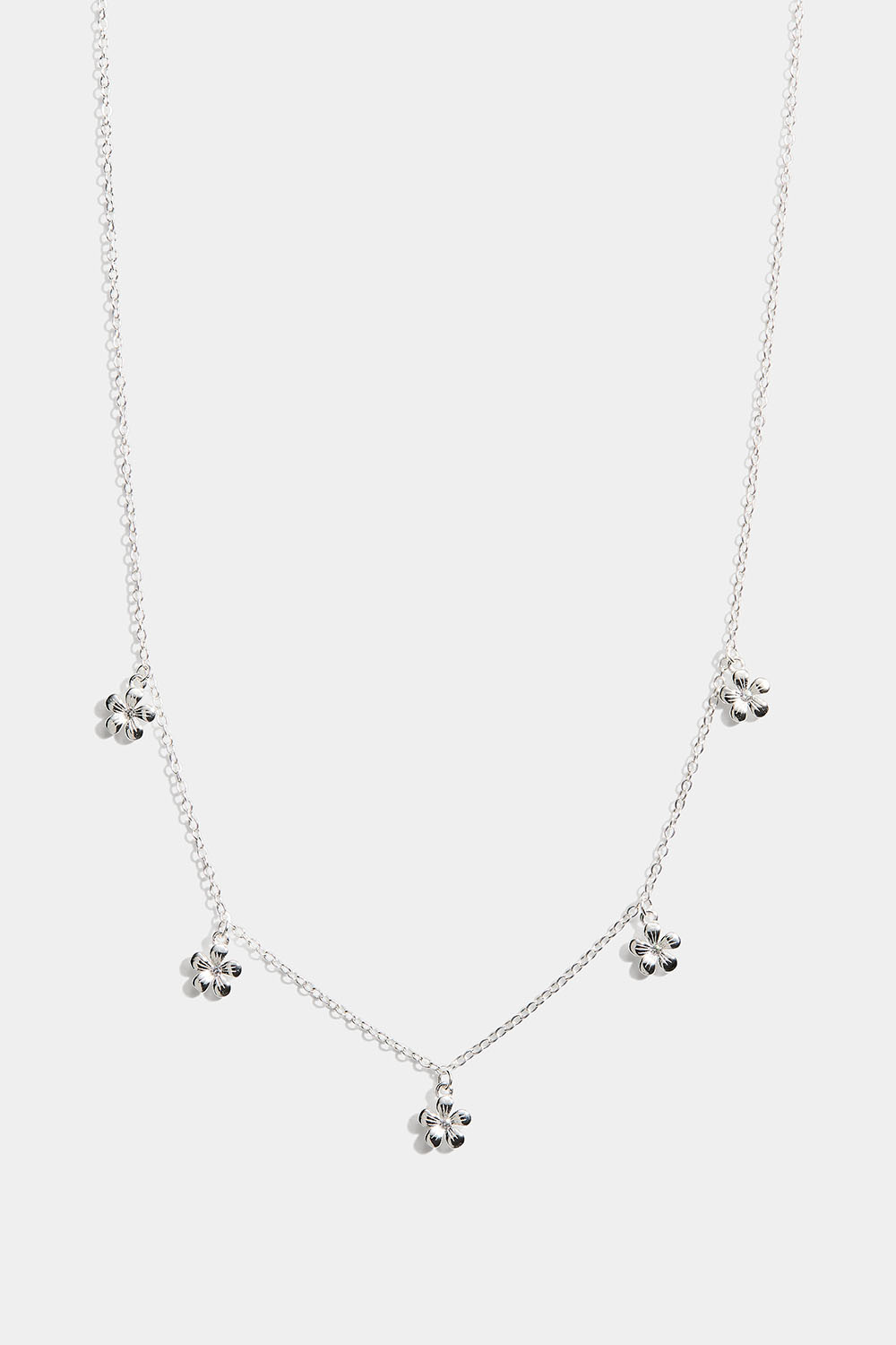 Aito hopeakaulakoru, jossa riippuvia kukkia